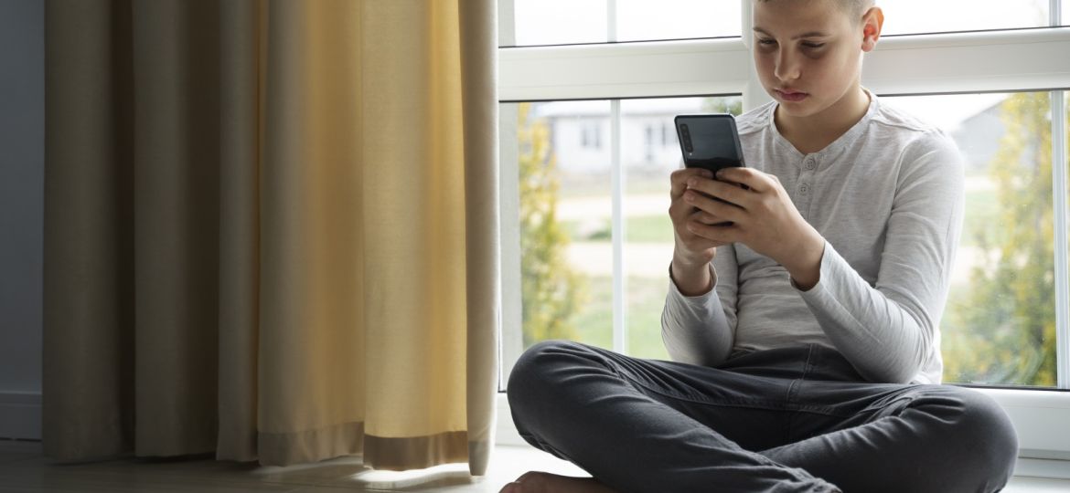 2025 Freepik.com teen with smartphone